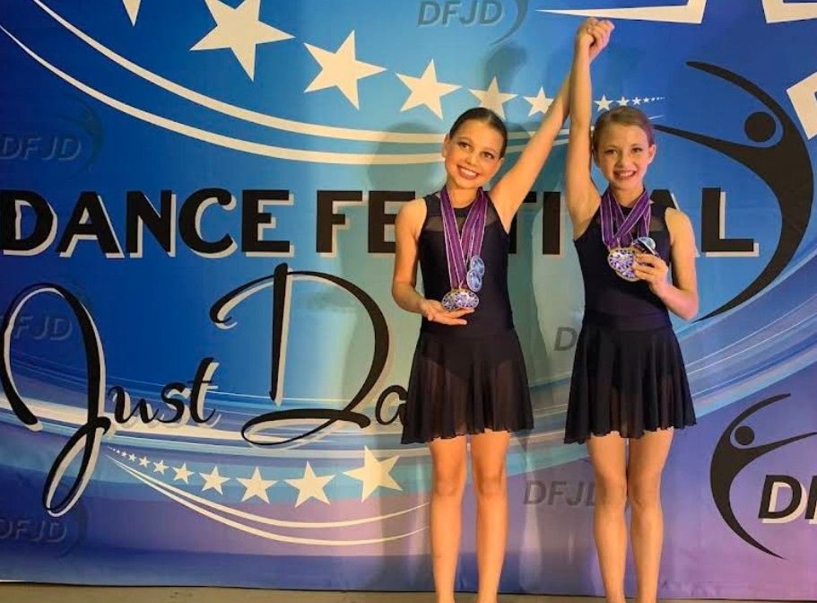 Two dancers with their medals at a dance festival