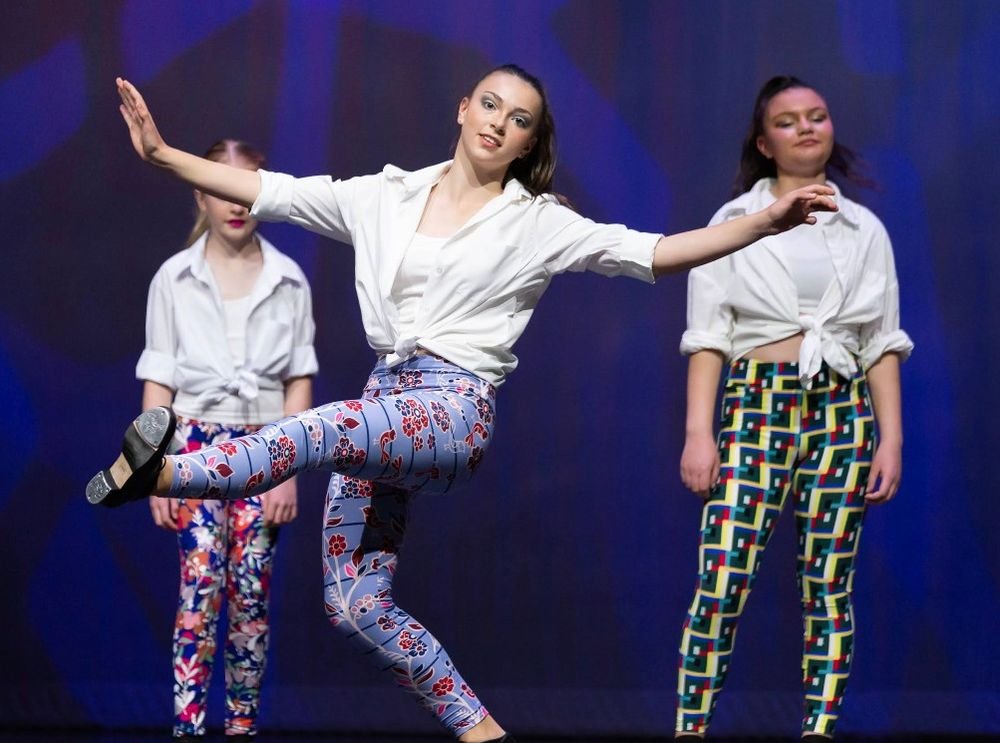 Three tap dancers in white shirts